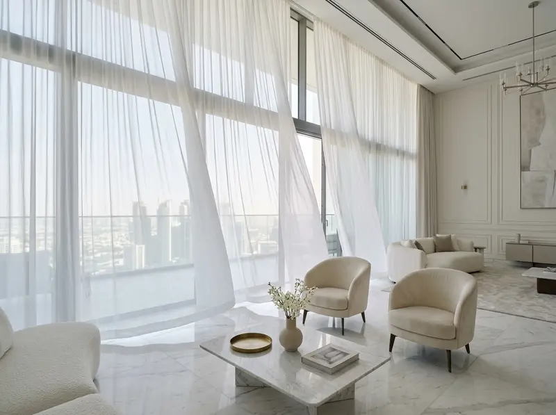 White sheer curtains softening daylight across a bright lounge